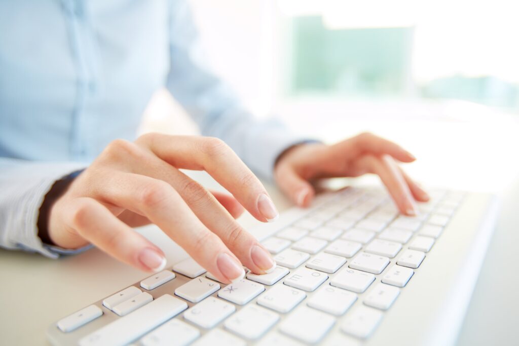 Close-up of female professional typing on keyboard