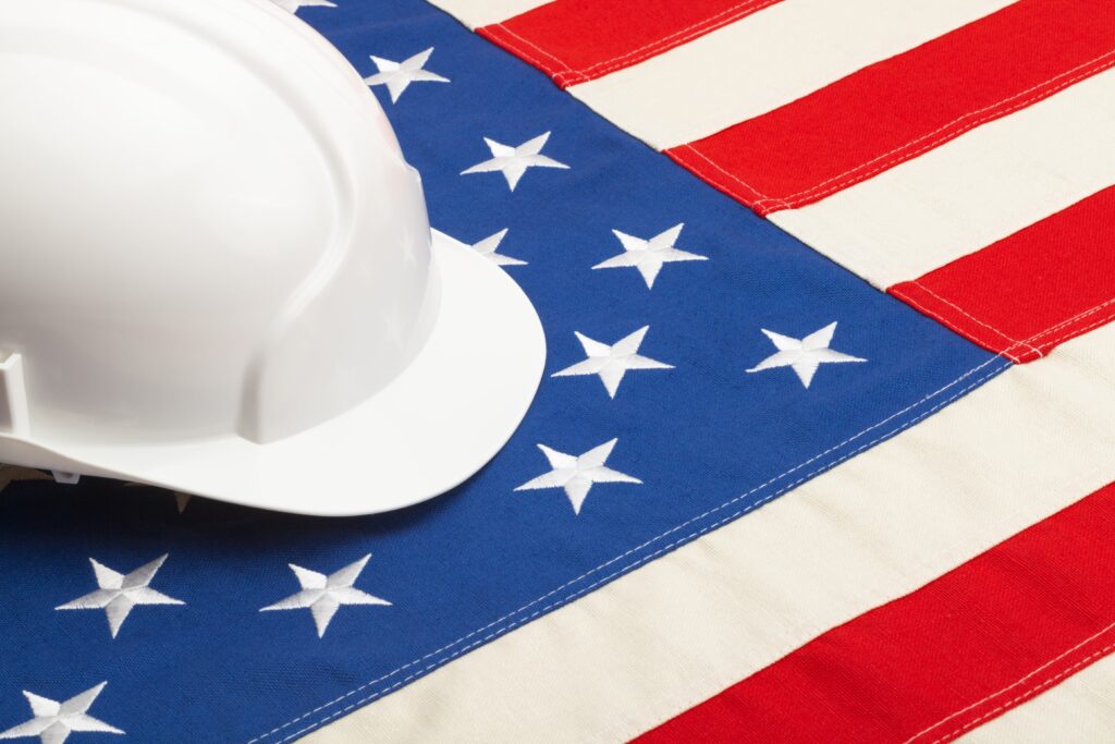 White hard hat sitting on American flag