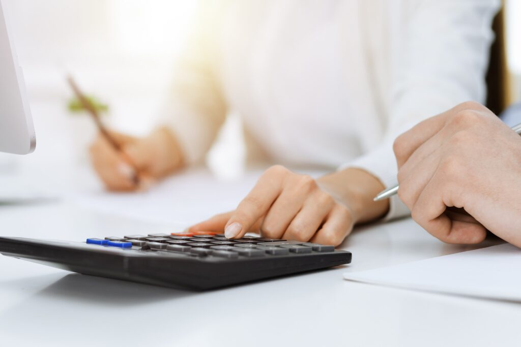 Close-up of hand using calculator