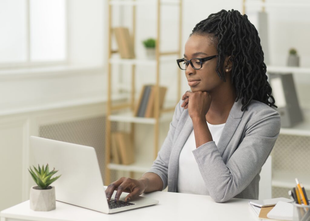 Young female employee using laptop