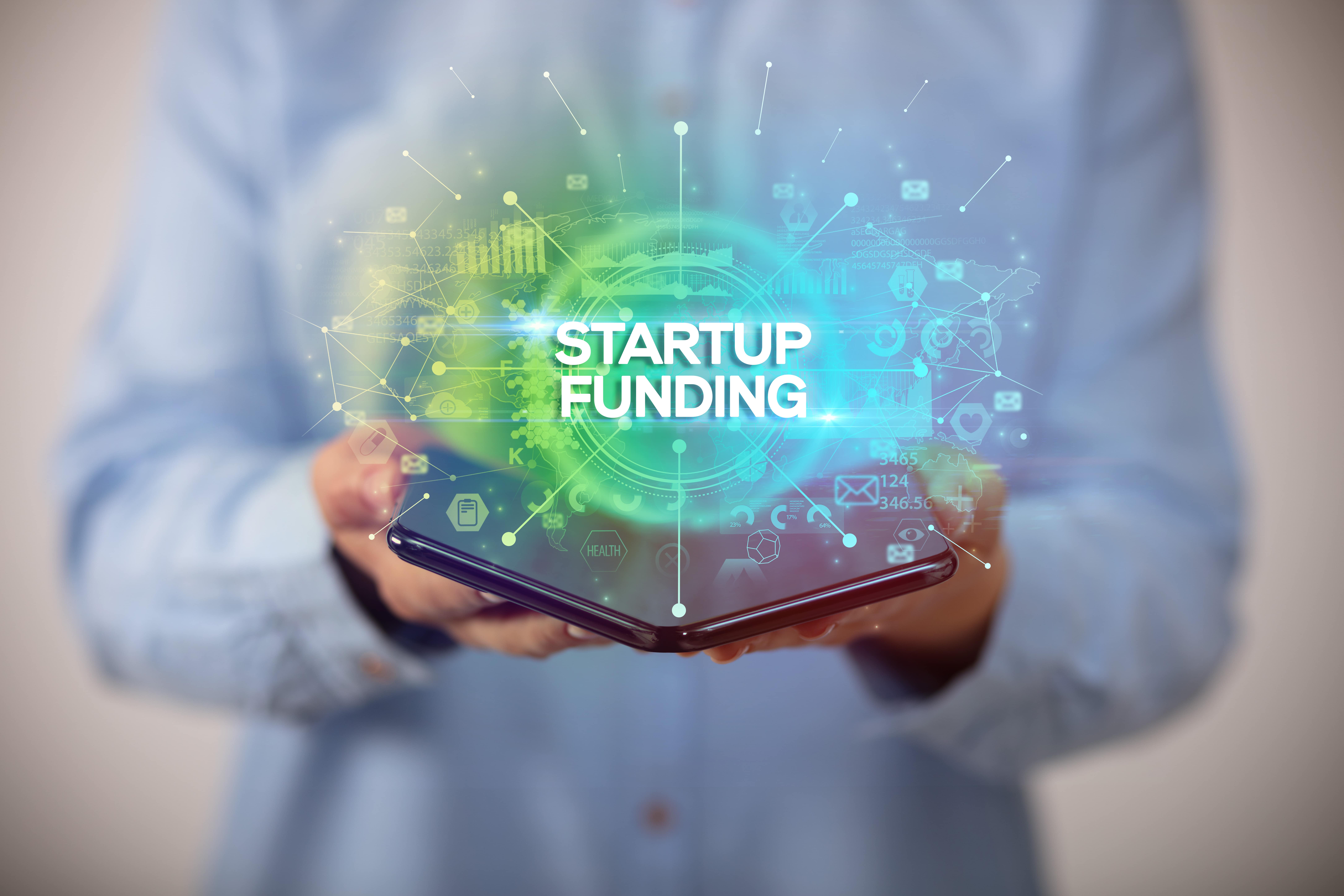 graphic illustration of hands opening tablet, startup funding text